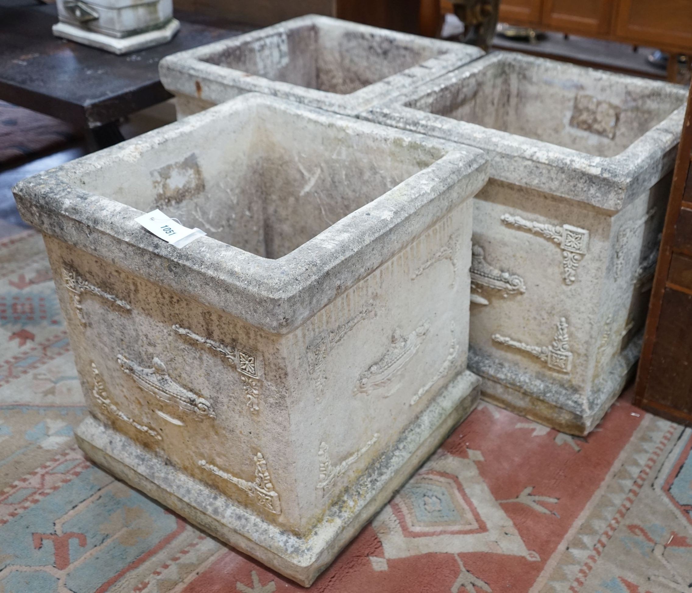 A set of three square reconstituted stone garden planters, width 47cm, height 50cm